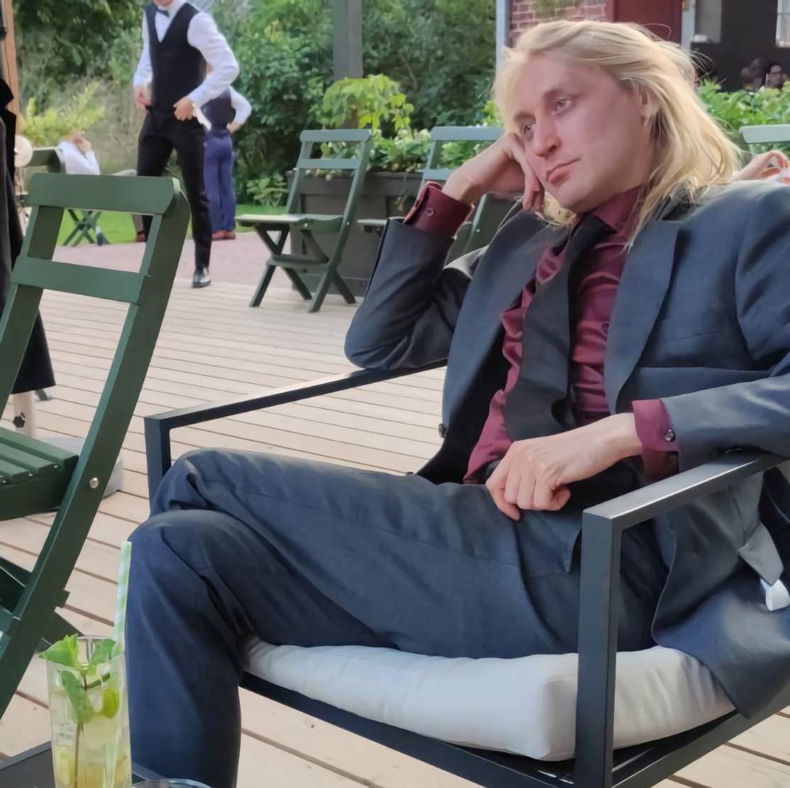 The author gazes into the distance with a glassy look at a wedding, hoping he were writing books right now
